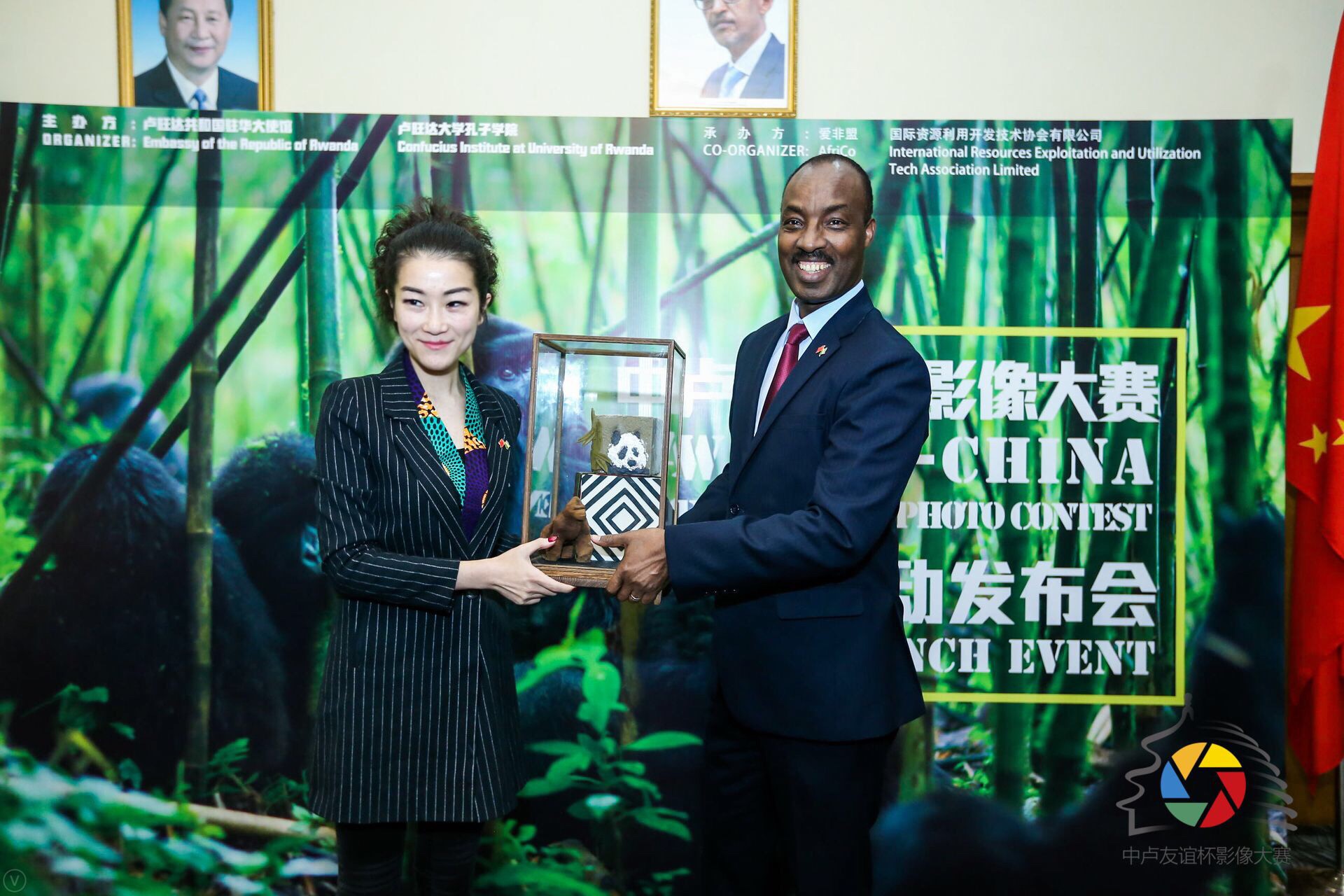 盧旺達共和國駐中國大使查爾斯&bull;卡勇加閣下（右）向&ldquo;中盧友誼杯&rdquo;影像大賽承辦方愛非盟(AfriCo)創(chuàng)始人李青女士（左）互贈禮物